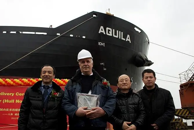 Delivery of ‘ Aquila’: left to right: Zhuang Tian, LR surveyor in charge Nantong; Master - M/V Aquila; Tae-Bok Kwak, LR project manager; Xiaofeng Yang, LR site office team leader