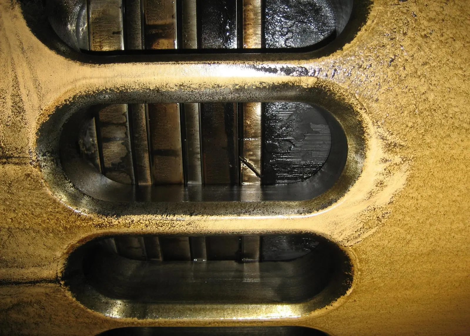 Piston with rings, as seen through scavenge ports (GL)