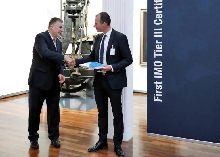 Kasper Moos, DFDS head of technical organisation (right) and Arnd Löttgen, member of the executive board, MAN Diesel & Turbo with the Tier III compatibility certificate from DNV GL