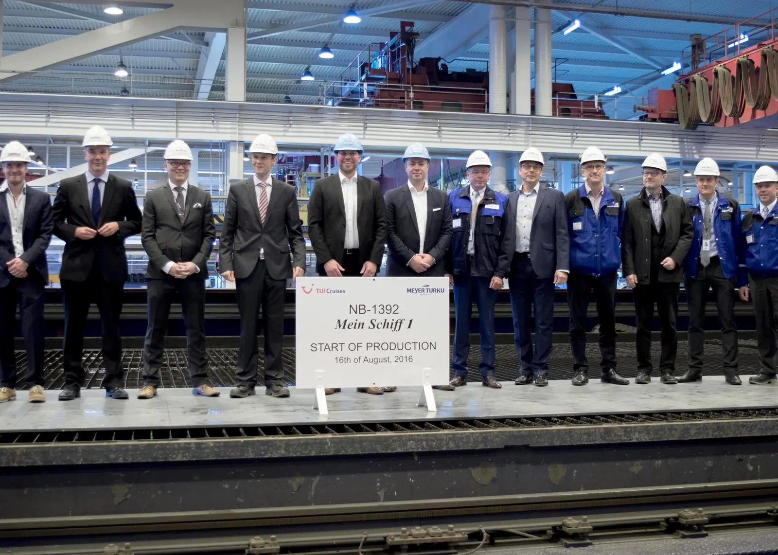 Delegates from Meyer Turku and TUI Cruises attend the steel cutting ceremony for the new 'Mein Schiff 1'