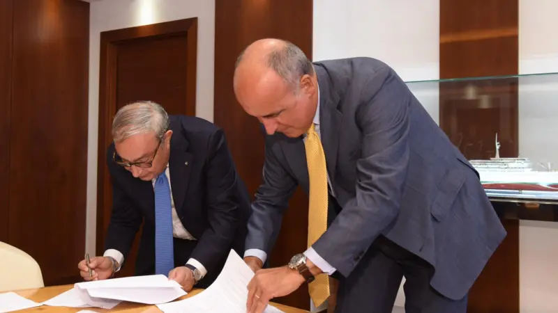 Giuseppe Bono, CEO, Fincantieri and Sandro De Poli, president and CEO, GE Italy agree to develop the Shipboard Pollutant Removal System