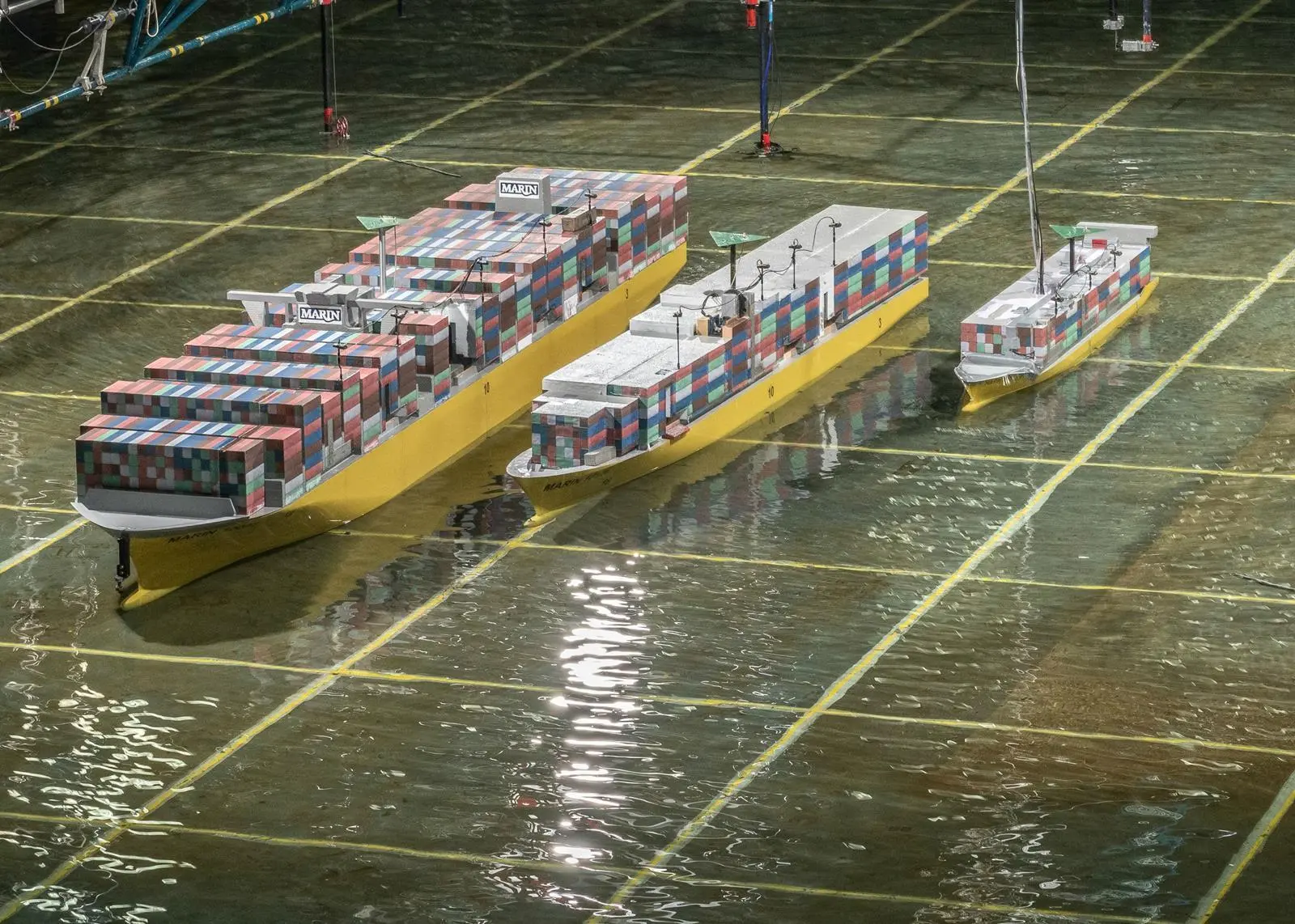 Scale models of a large containership, panamax and feeder in the test basin at MARIN.
