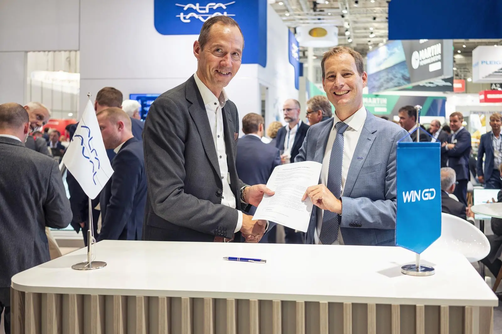 Peter Nielsen, President, Marine Separation & Heat Transfer Equipment, Alfa Laval & Dominik Schneiter, Vice President R&D, WinGD at the signing of a new joint programme agreement at SMM 2022 Hamburg, Germany