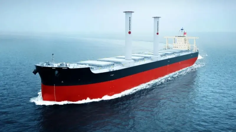 The image shows the vessel Camellia Dream at sea equipped with Norsepower rotor sails